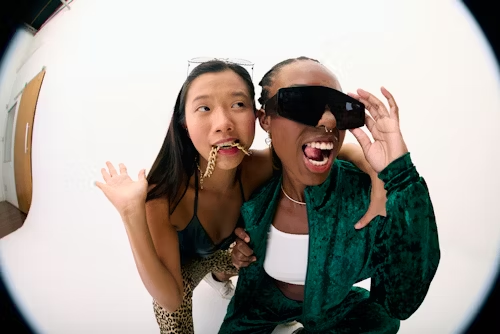 Two bold women with expressive poses, symbolizing unleashed desires and self-expression.