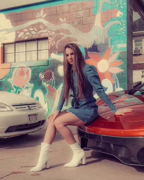 A confident woman sitting on a sports car, representing the bold and rebellious spirit of the platform.