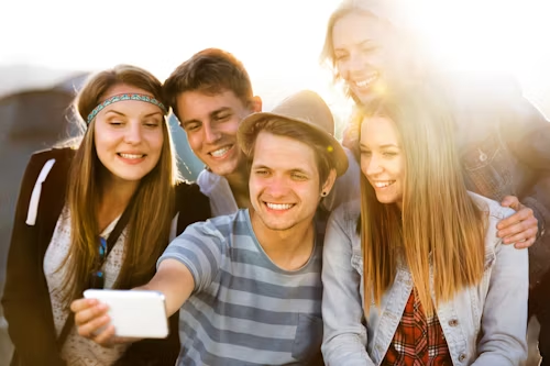 A group of young people taking a selfie outdoors, representing viral social engagement.