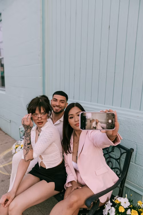 Three people taking a selfie, symbolizing social interaction and self-expression.